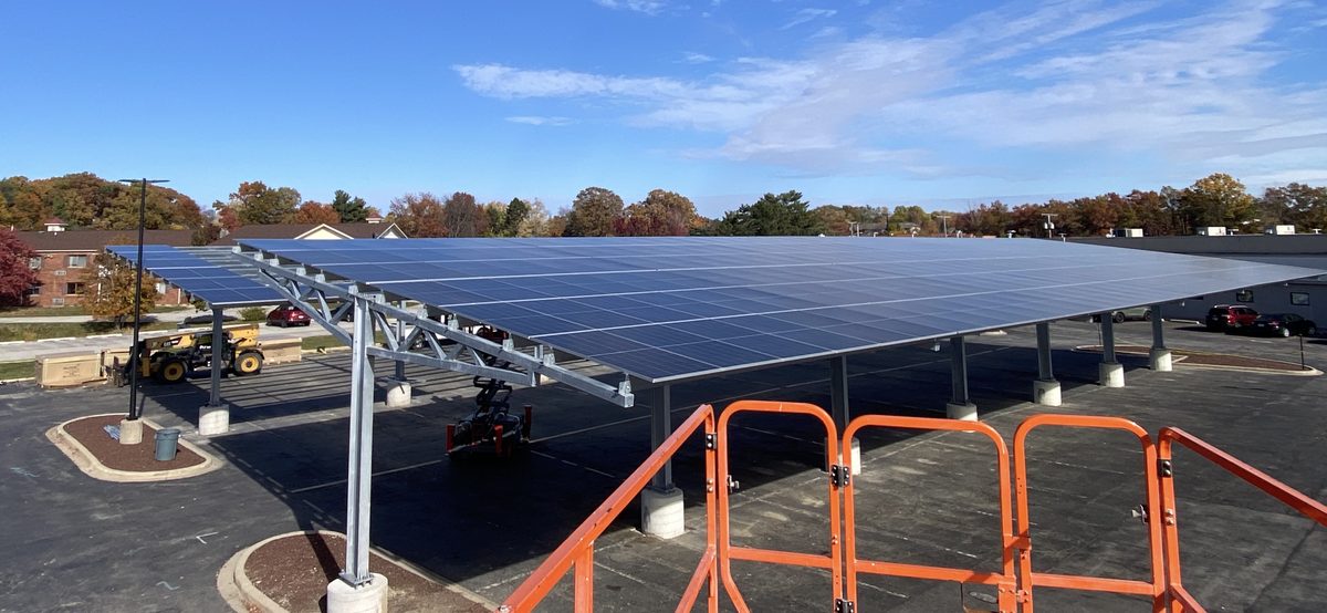 Completed solar carport over a parking lot in autumn