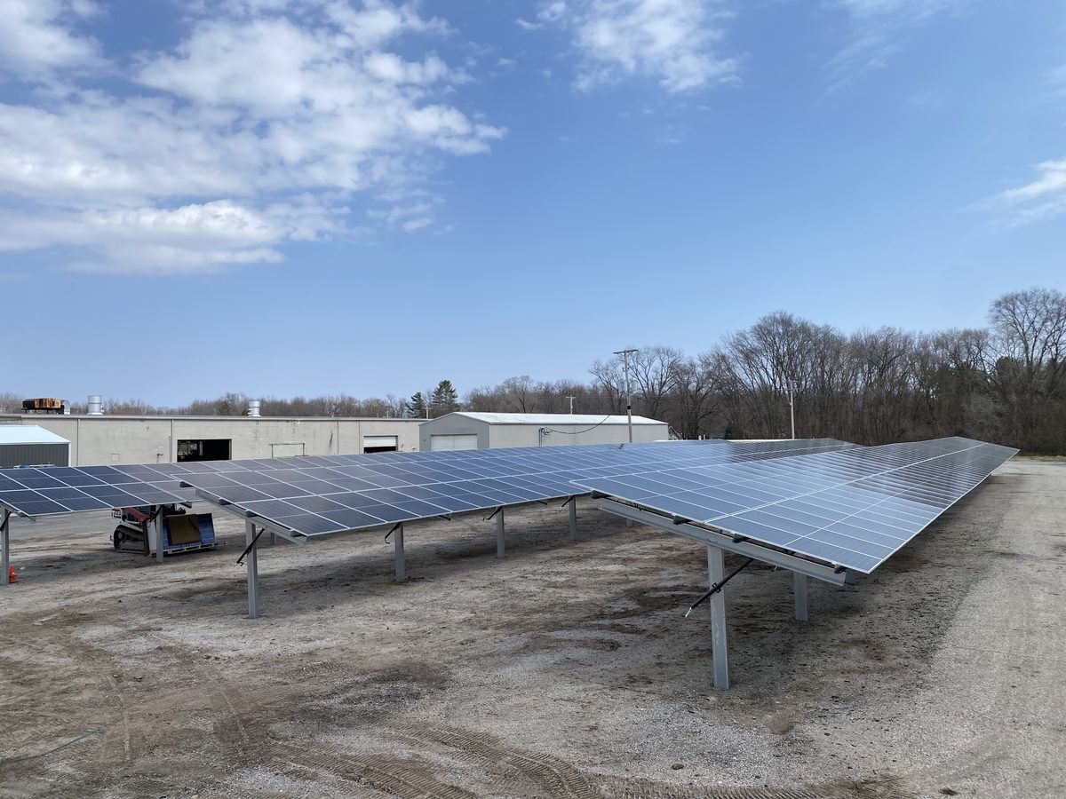 Long rows of ground mount solar panels on a commercial lot