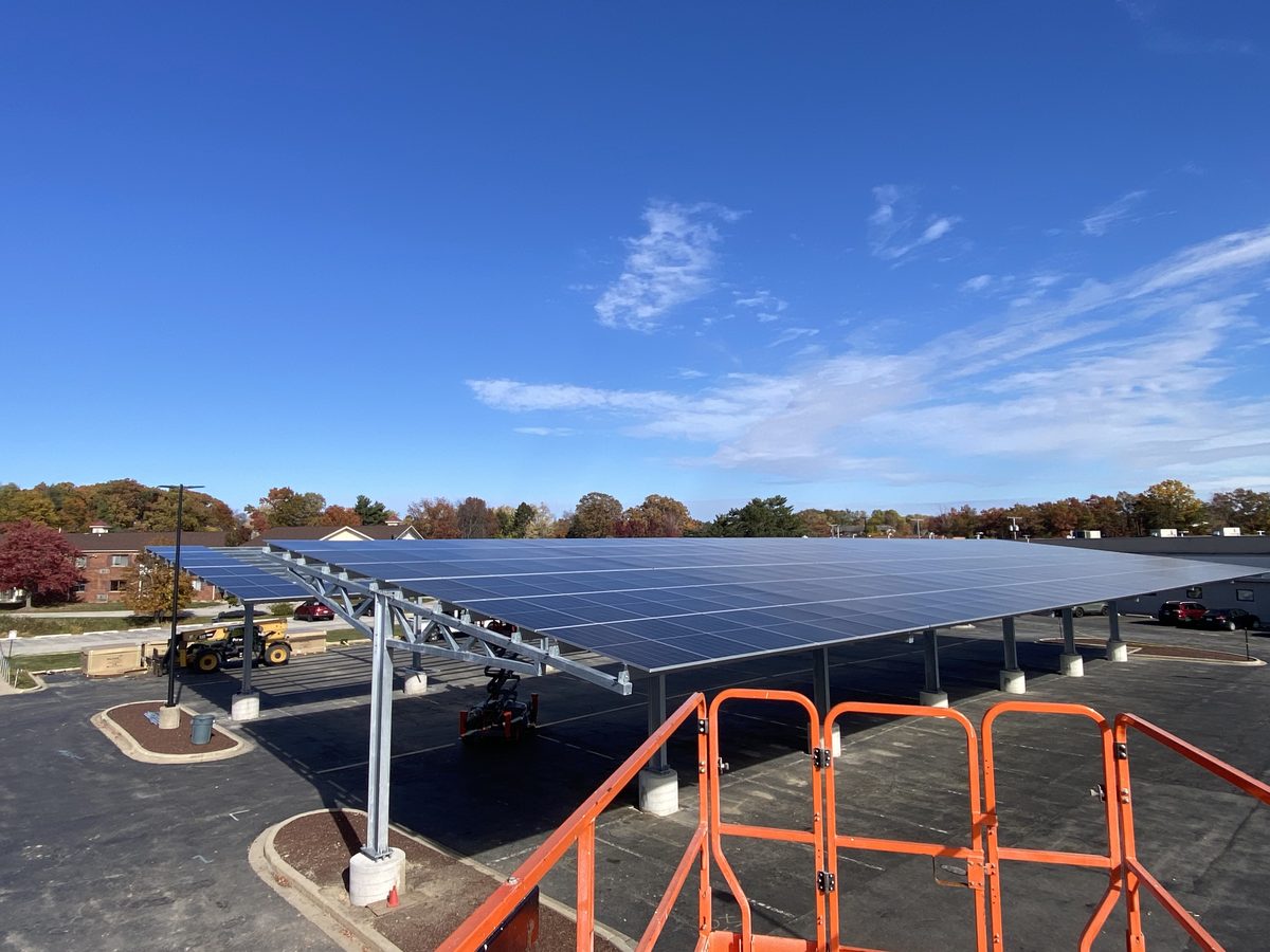 Finished steel solar carport canopy over a parking lot