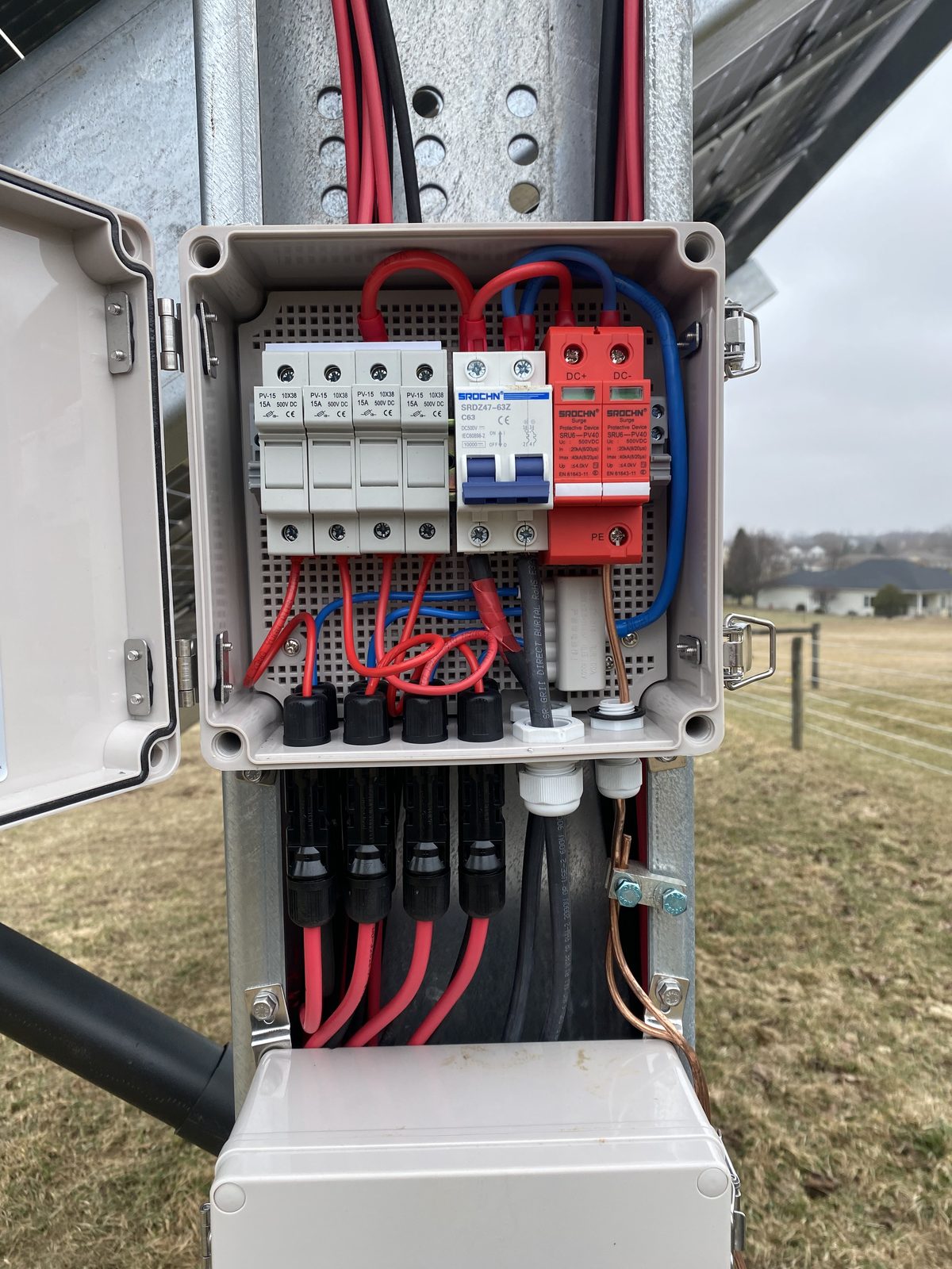 Open DC combiner box with fuses, breaker and surge protection