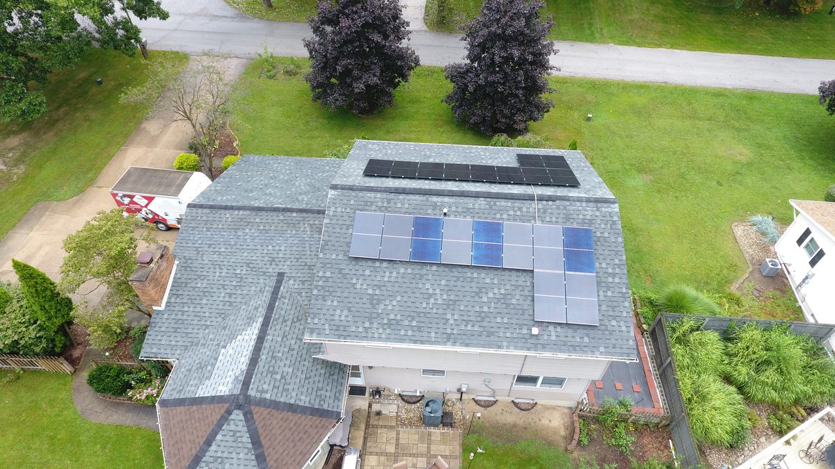 Aerial view of two solar arrays on a residential roof